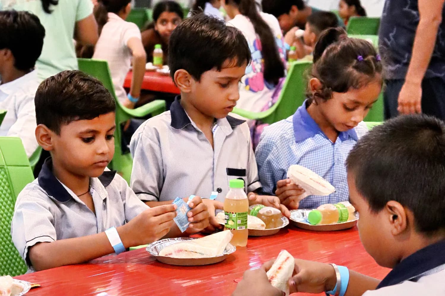 School children eating a group meal in the indoor dining hall