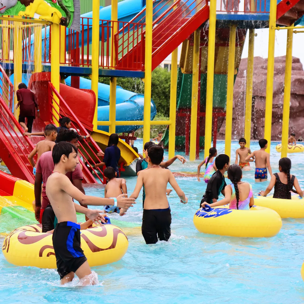 Children playing on tubes at the jungle-themed water play structure