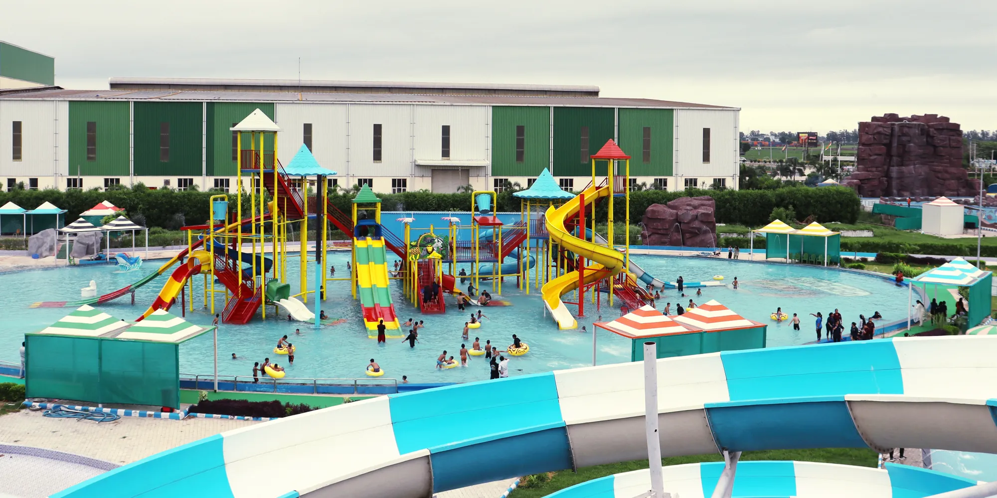 View across the water park showing the pools, slides and play station